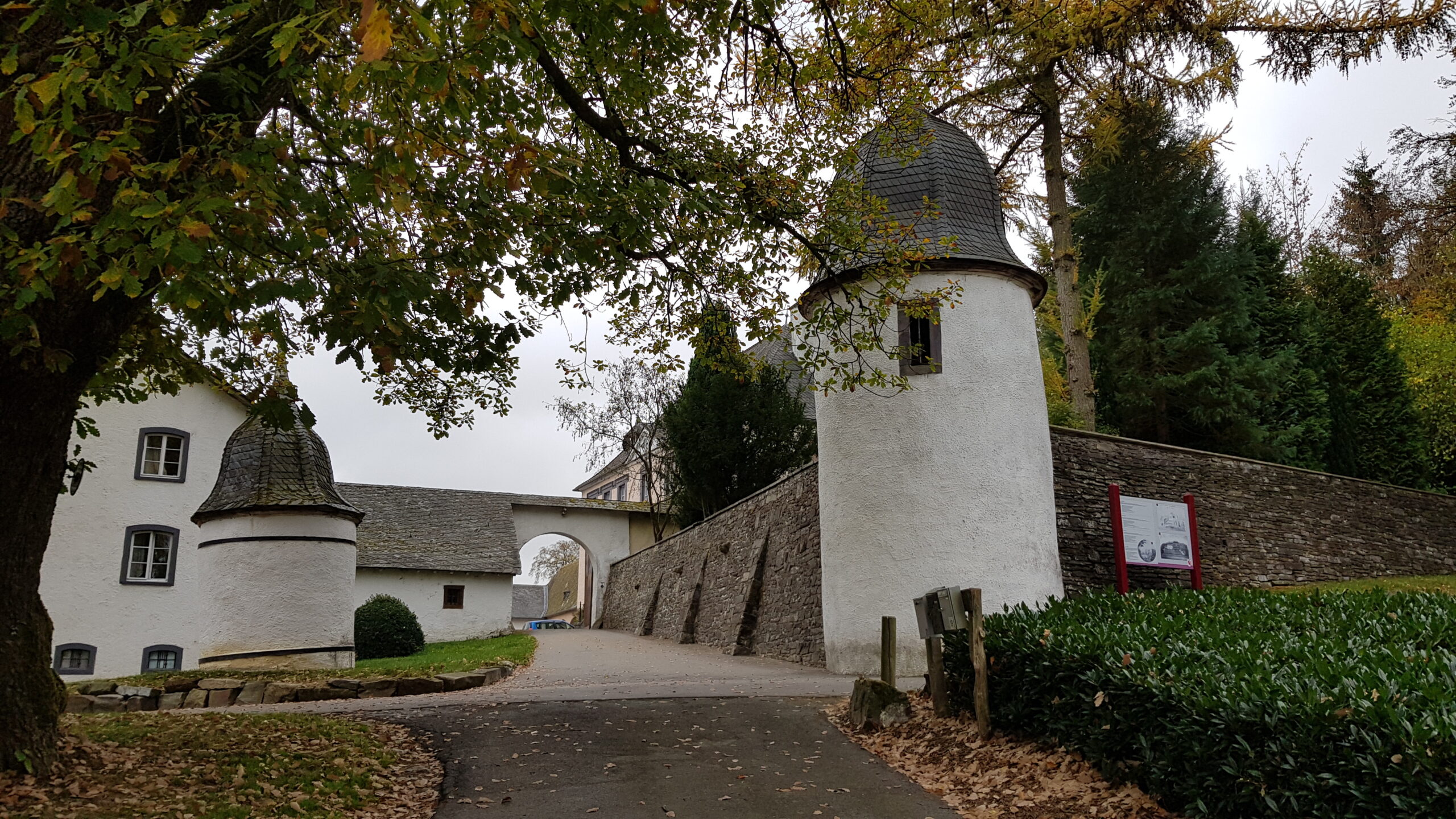 Toegang tot Schloss Wallerode met witte torens en bomen
